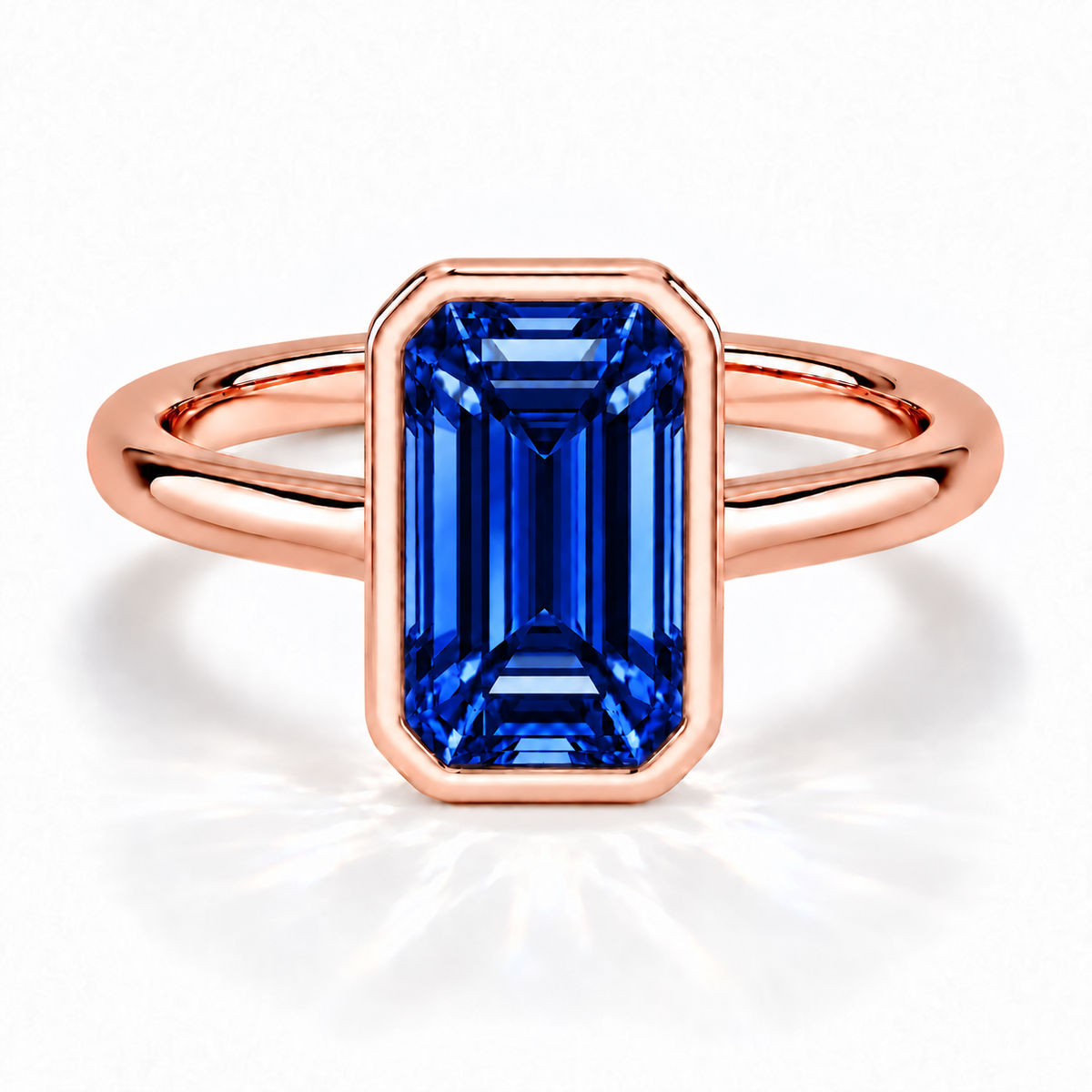 Gia Verlobungsring mit blauem Laborsaphir im Emerald-Schliff und Bezel-Fassung in Roségold – Frontalansicht auf weißem Hintergrund