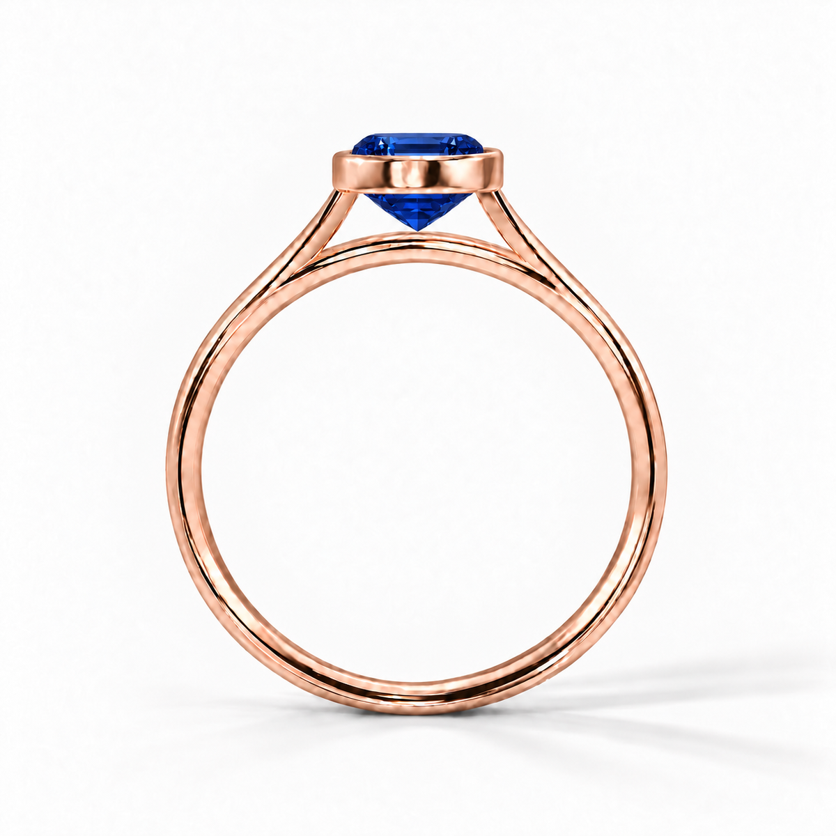 Gia Verlobungsring mit blauem Laborsaphir im Emerald-Schliff und Bezel-Fassung in Roségold – Profilansicht auf weißem Hintergrund