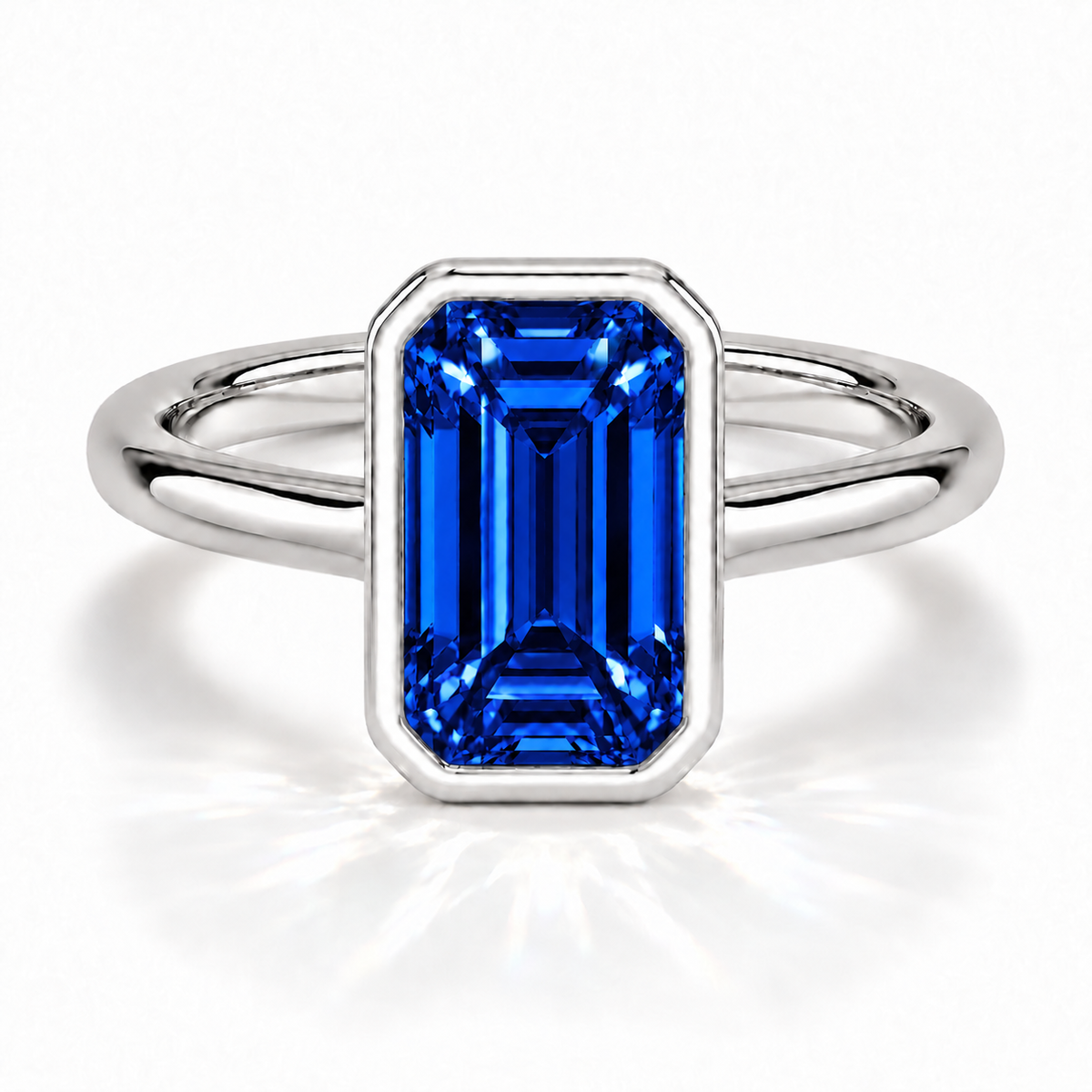 Gia Verlobungsring mit blauem Laborsaphir im Emerald-Schliff und Bezel-Fassung in Weißgold – Frontalansicht auf weißem Hintergrund
