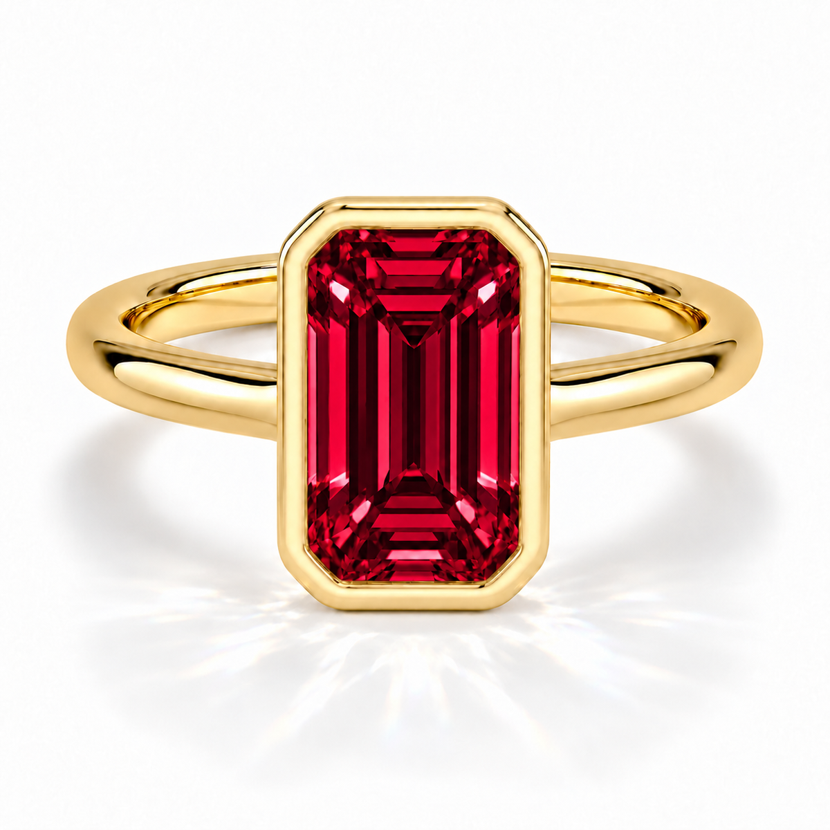 Gia Verlobungsring mit rotem Laborrubin im Emerald-Schliff und Bezel-Fassung in Gelbgold – Frontalansicht auf weißem Hintergrund